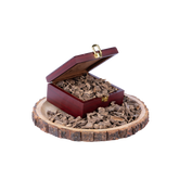 A box of Zodiaura's Agarwood Muri (Hindi) incense chips displayed on a wooden stand, with the box lid open revealing the chips inside.