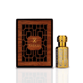 A luxurious looking perfume bottle with a gold cap next to its packaging, which features a wood-like texture with intricate cut-out patterns.
