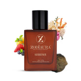 A square-shaped bottle of Zodiaura Serene perfume EDP spray with a black cap. The bottle is displayed in front of a white background with an arrangement of fruits and flowers around it, suggesting the floral fruity musky fragrance accords.